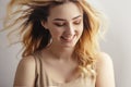 Studio portrait of a beautiful sincerely laughing girl, young woman face with curly hair disheveled from wind , the concept of Royalty Free Stock Photo