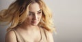 Soft studio portrait of a young woman, girl face with curly hair disheveled from wind , the concept of natural beauty, Royalty Free Stock Photo