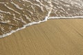 Soft surf on the beach, texture of the sand and water. Royalty Free Stock Photo