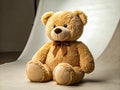 Soft teddy bear sitting on a plain surface, showcasing its plush texture Royalty Free Stock Photo