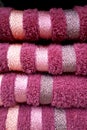 Soft terry towels in purple folded on top of each other.