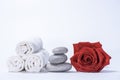 Soft terry towels, rose and stones for skin care and spa on a white background Royalty Free Stock Photo