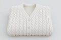 Cozy white cable-knit cardigan neatly folded for seasonal wear in cool weather Royalty Free Stock Photo
