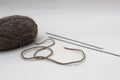 Skein of yarn with knitting needles on a gray background