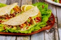 Soft tortillas stuffed with lettuce, meat and cheese on wooden background. Mexican food concept Royalty Free Stock Photo