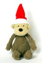 A soft toy monkey wearing a Santa Claus Christmas hat