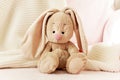 A soft toy rabbit in the nursery on the bed is waiting for the baby Royalty Free Stock Photo