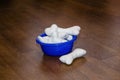 Soft toys - bones for dog in a dish. Artificial chewing toys for puppies. Royalty Free Stock Photo