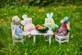 Soft toys having a dinner with clay figurines of fruits and vegetables Royalty Free Stock Photo