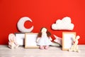 Soft toys and photo frames on table  red background, space for text. Child room interior Royalty Free Stock Photo