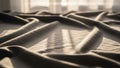Folds of fabric cover a surface with light streaming in from a Royalty Free Stock Photo