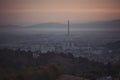 soft view of purple blue hour sky above scenic cityscape covered by haze and mist. Royalty Free Stock Photo