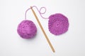 Soft violet woolen yarn, knitting and crochet hook on white background, top view Royalty Free Stock Photo