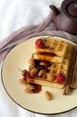 Soft waffles jam almonds strawberries round plate Royalty Free Stock Photo