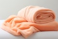 Soft and warm fabric folded in a pile, in various shades of pink and white.