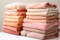Soft and warm fabric folded in a pile, in various shades of pink and white.