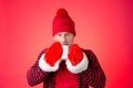 A man drinks a hot drink. Cold weather. Red background Royalty Free Stock Photo