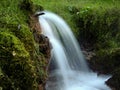 Soft waters running on rocks. Close-up of running water as a picture background Royalty Free Stock Photo