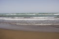 Soft wave of blue ocean on sandy beach.