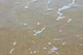 Soft wave of blue ocean on sandy beach.