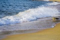 Soft wave hitting sandy beach under bright sunny day Royalty Free Stock Photo