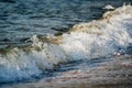 Soft wave hitting sandy beach under bright sunny day Royalty Free Stock Photo