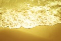 Soft wave of the sea on the sandy beach. In shades of yellow