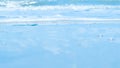 Soft waves with bubbles foams of clear blue water ocean sea on tropical sand beach Royalty Free Stock Photo