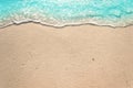 Soft waves with foam of blue ocean on the sandy beach