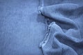 Soft wavy folds on the corduroy. Durable ribbed fabric. Close-up. Detail. Blue fabric backdrop with copy space Royalty Free Stock Photo