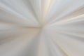 Soft white and beige radial zoom blur background with smooth light rays, bright center and minimal gradient depth. Royalty Free Stock Photo