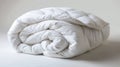 A soft white blanket on white backdrop. Hypoallergenic duvet for year-round comfort