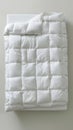 A soft white blanket on white backdrop. Hypoallergenic duvet for year-round comfort