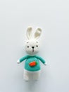 Soft white crochet bunny. on a white background.