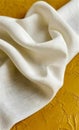 Elegant White Fabric Drape on Muted Yellow Background. Royalty Free Stock Photo