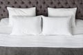 Soft white pillows on comfortable bed