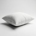 Soft White Square Pillow Resting on a White Studio Background Royalty Free Stock Photo