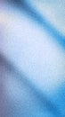Soft white to pale blue and subtle violet abstract gradient featuring dynamic shadows and a pronounced grainy texture. An elegant Royalty Free Stock Photo