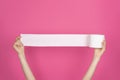 Soft, white toilet paper roll on bright pink background. Hygiene concept Royalty Free Stock Photo