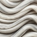 Soft, white wool fibers appear in sinuous, parallel waves. The texture is smooth and Royalty Free Stock Photo