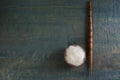 Soft white wool and spindle on blue wooden table, flat lay. Space for text Royalty Free Stock Photo