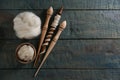 Soft white wool and spindles on blue wooden table, flat lay. Space for text Royalty Free Stock Photo