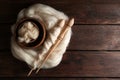 Soft white wool and spindles on wooden table, top view. Space for text Royalty Free Stock Photo