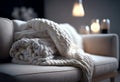 Soft white wool throw blanket on a cream colored sofa couch