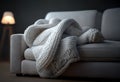 Soft white wool throw blanket on a cream colored sofa couch