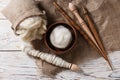 Soft wool and spindles on white wooden table, flat lay Royalty Free Stock Photo