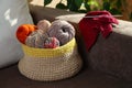 Soft woolen yarns, knitting and needles on brown sofa indoors Royalty Free Stock Photo