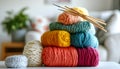 Soft woolen yarns with knitting needles and sweater on white table indoors Royalty Free Stock Photo