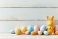 Soft Yellow Bunny and Colorful Easter Eggs Arranged on a Wooden Surface in Springtime Royalty Free Stock Photo