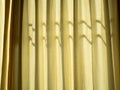 Soft yellow linen texture blinds curtains with sunlight through the windows. sun-blind Royalty Free Stock Photo